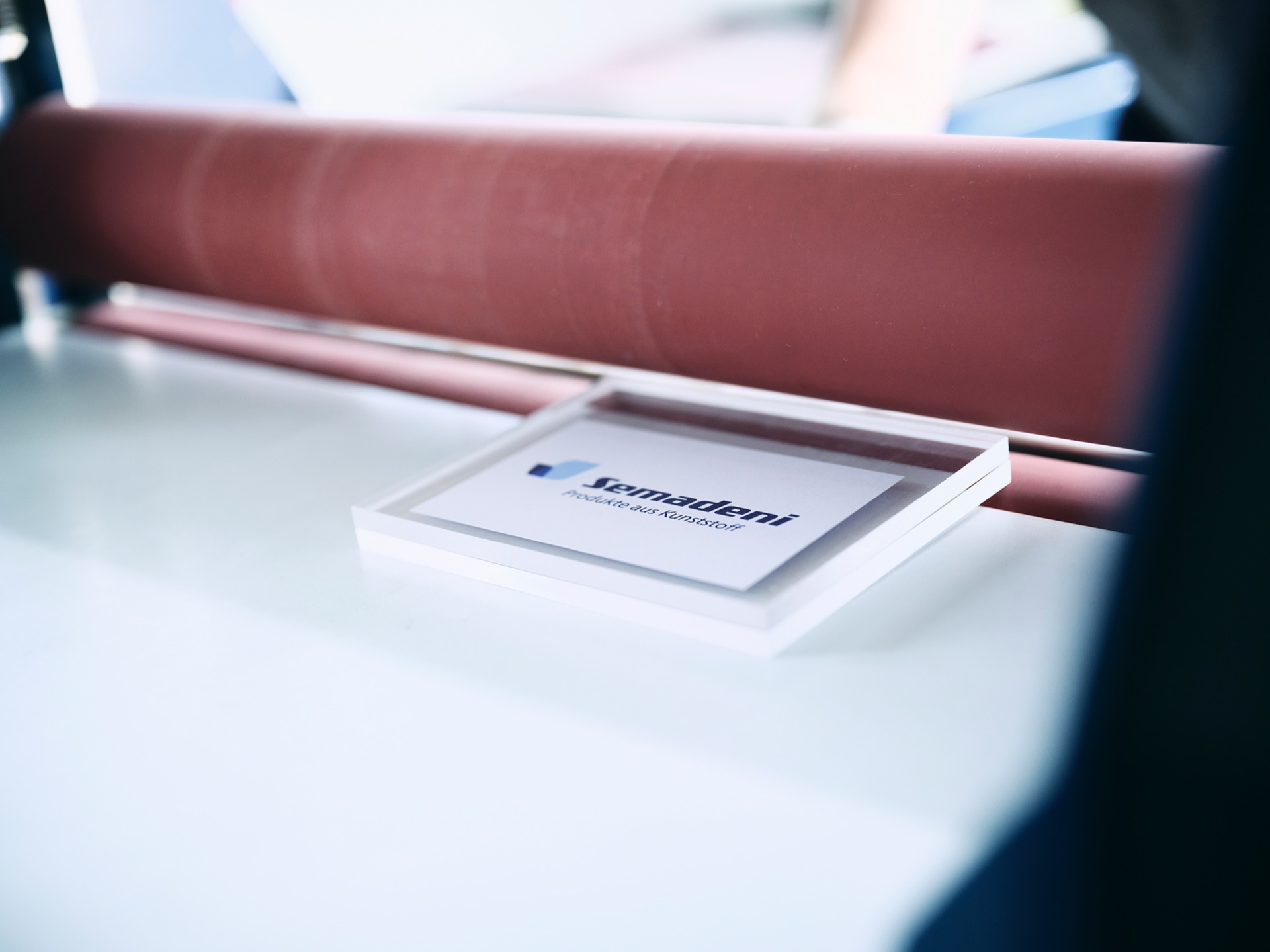 Finished laminated acrylic block with a permanently enclosed logo