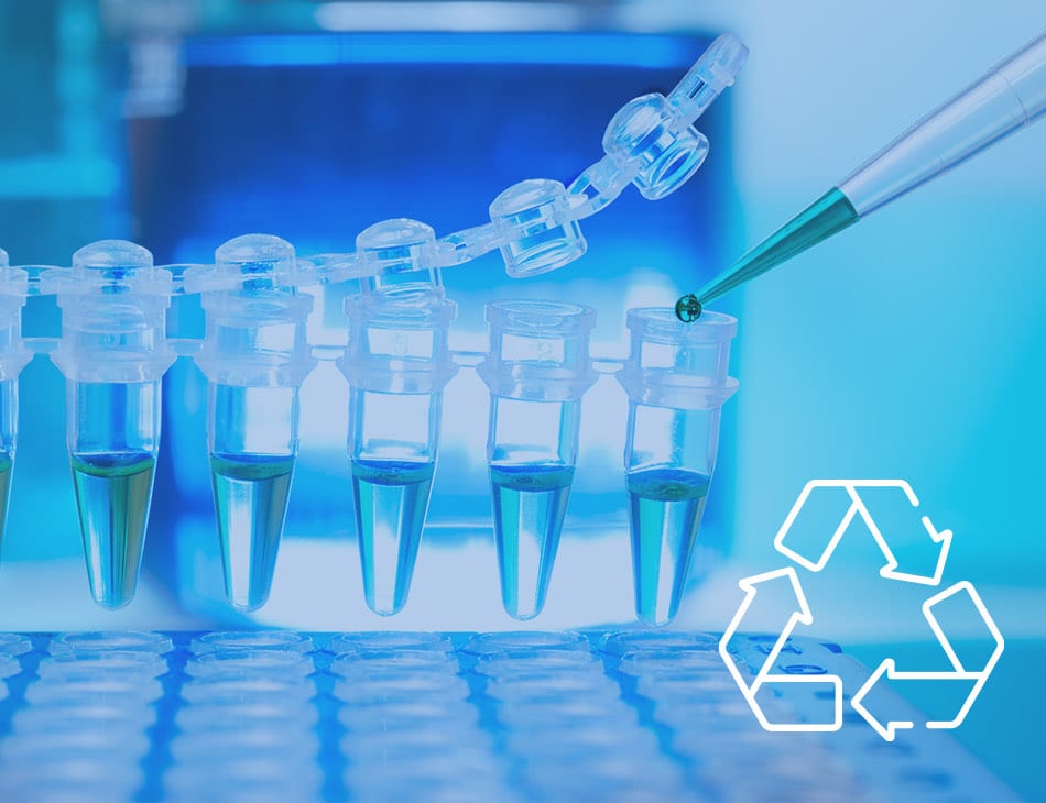 Laboratory pipette above reaction tubes, next to the recycling symbol