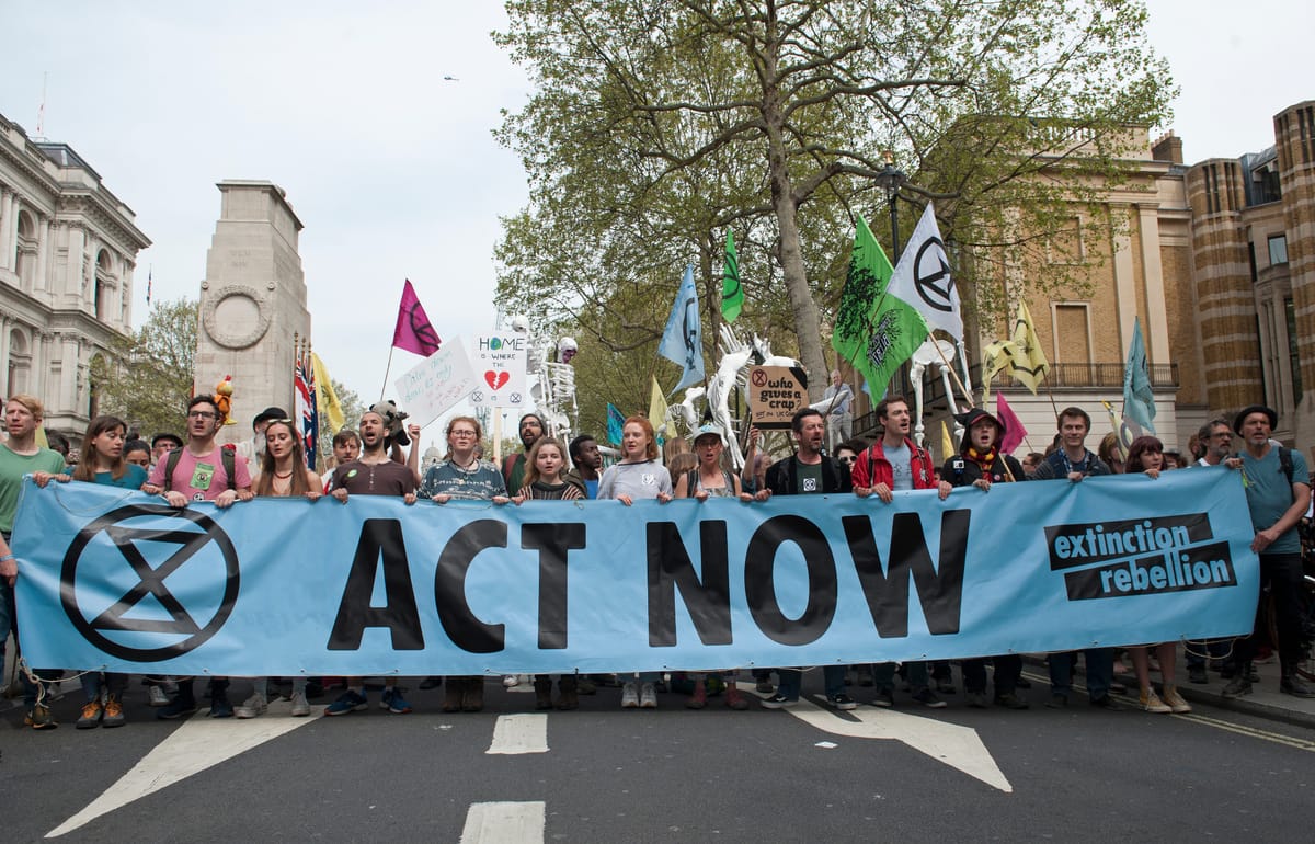 Extinction Rebellion march with an «Act Now» banner