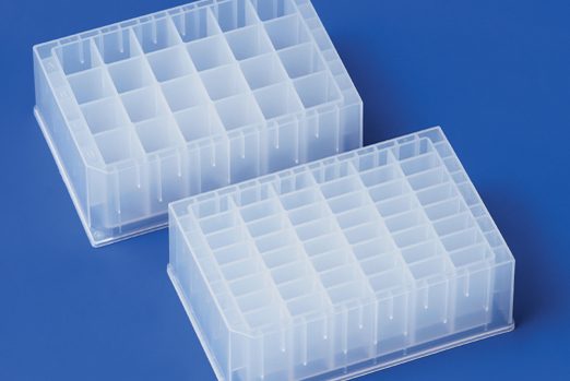 Two transparent deep well plates with their rectangular grid of wells