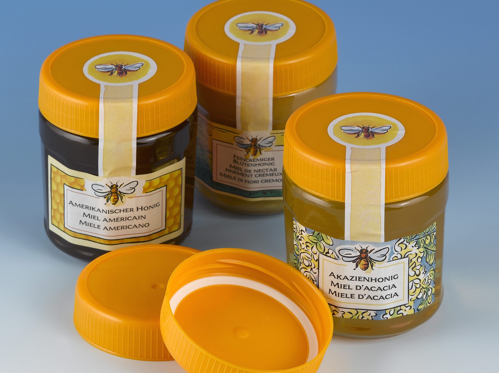 Honey tins and a separate screw lid in detail