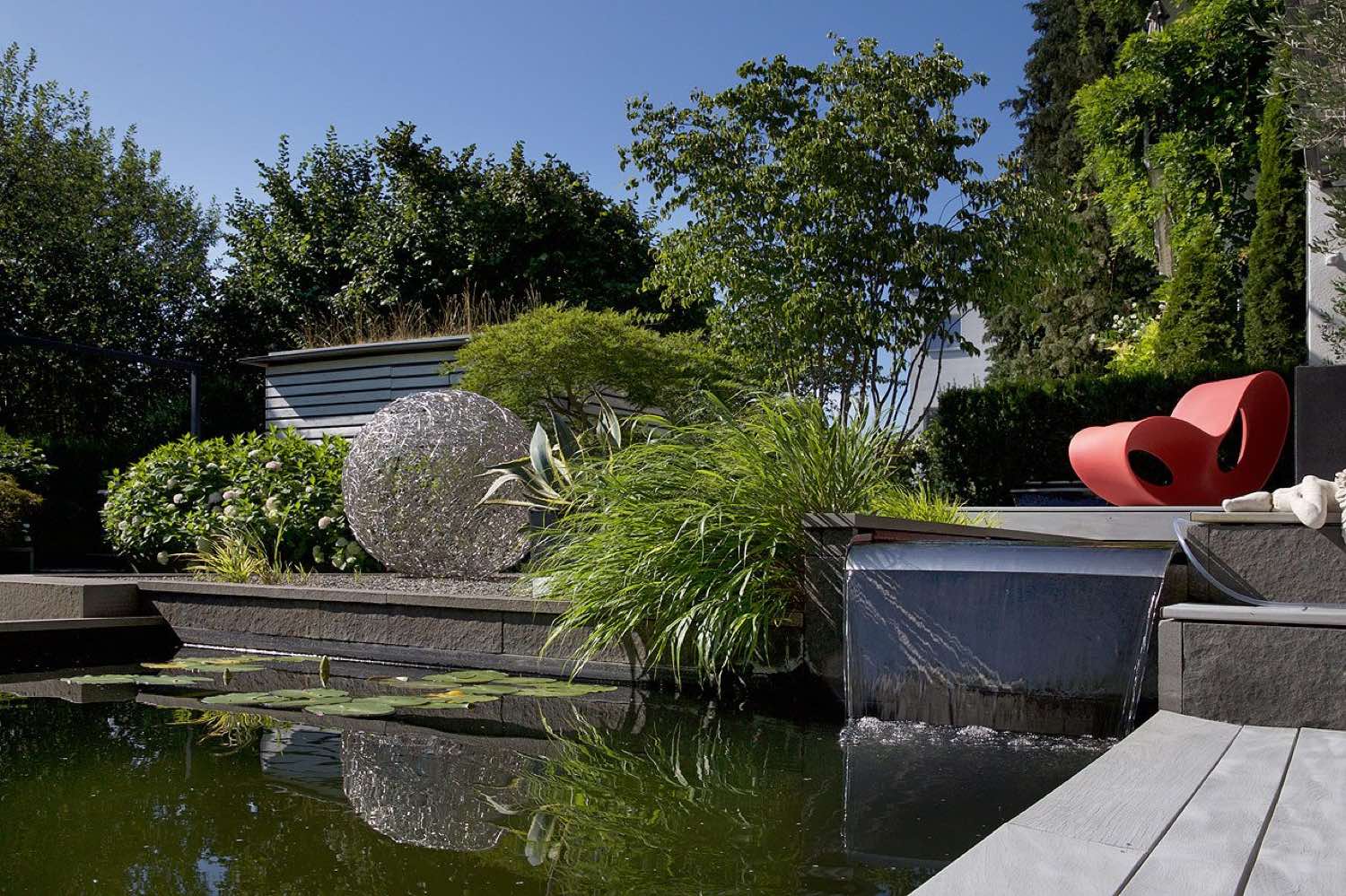 Upper and lower water basin with seating group and grasses